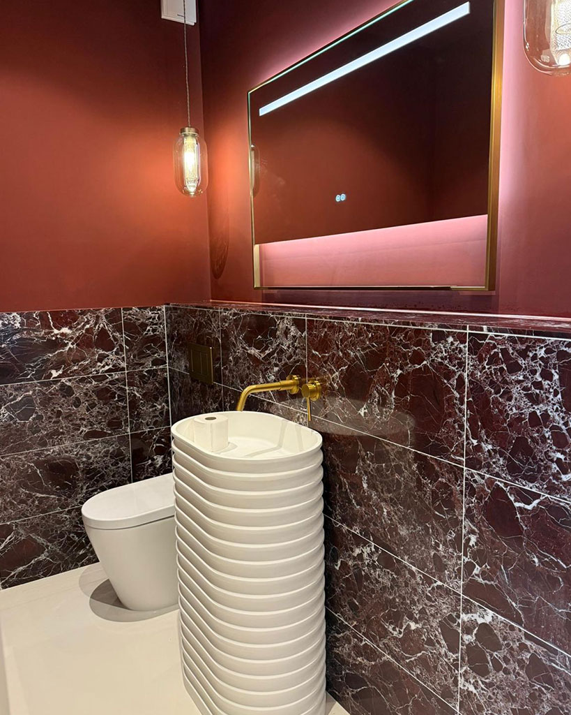 Fluted basin against red marble