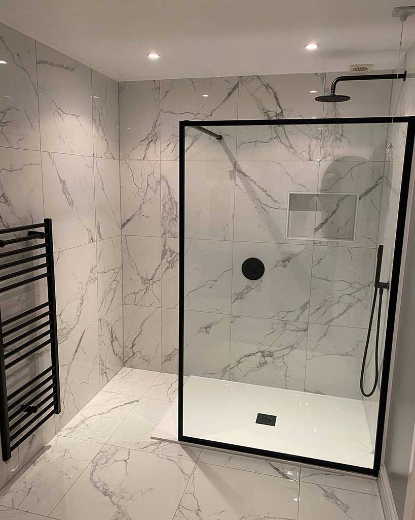 Finished walk-in shower with black-framed screen