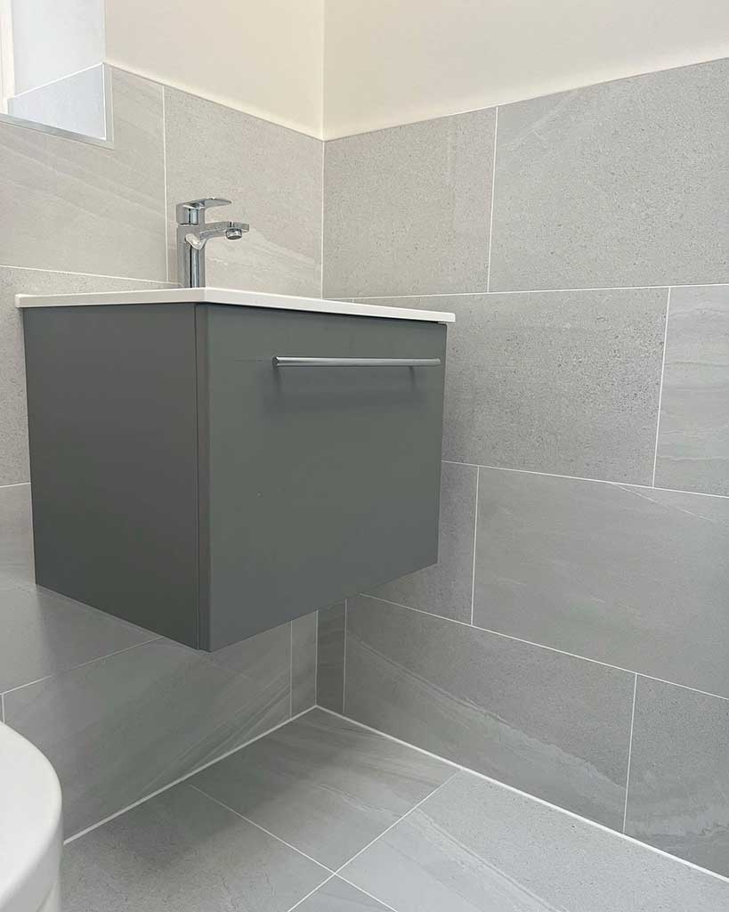Wall-hung vanity unit, grey tiles