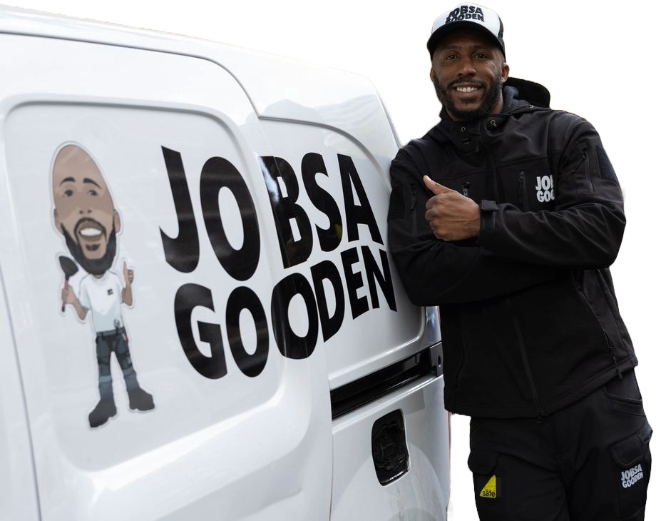 Carl Wilson leaning on the Jobsa Gooden van, giving a thumbs up