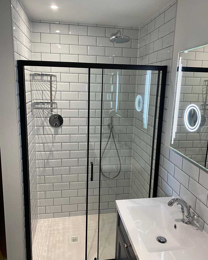 Metro-tiled shower with black-framed screen