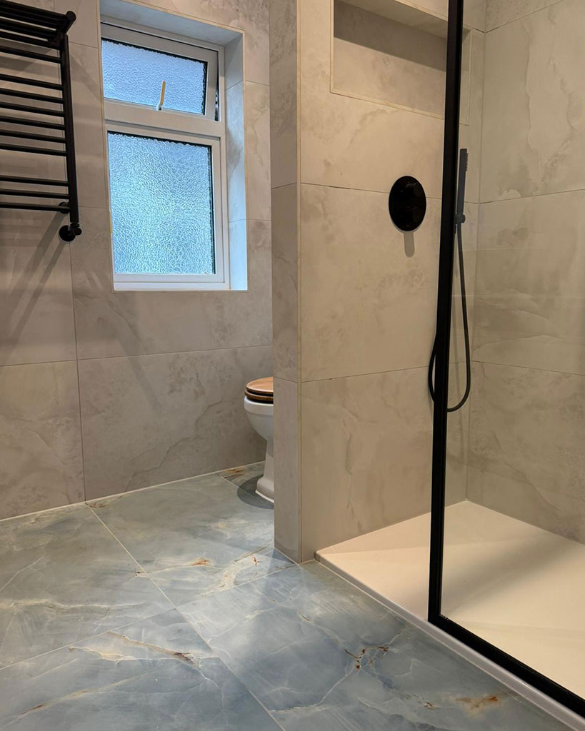 Walk-in shower with black-framed screen