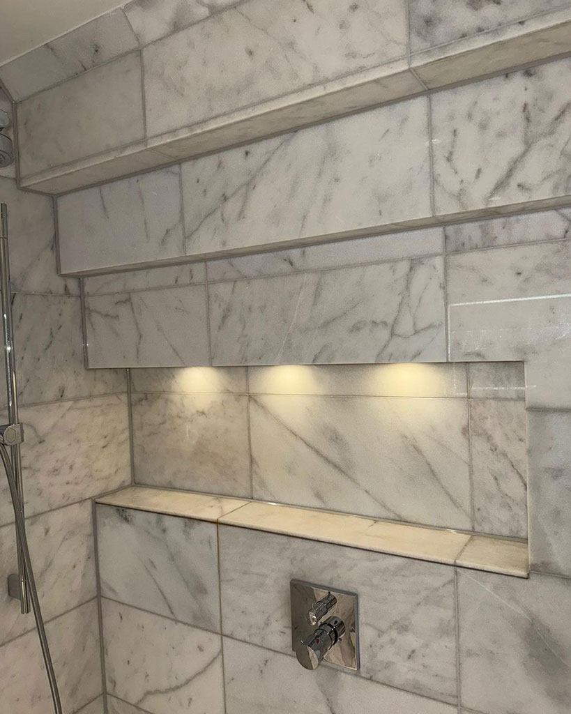 Clean sealant lines around lit tiled niches