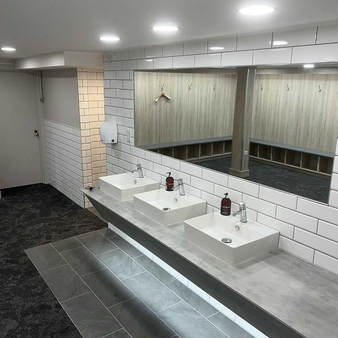 Commercial washroom with sealed basins and worktop