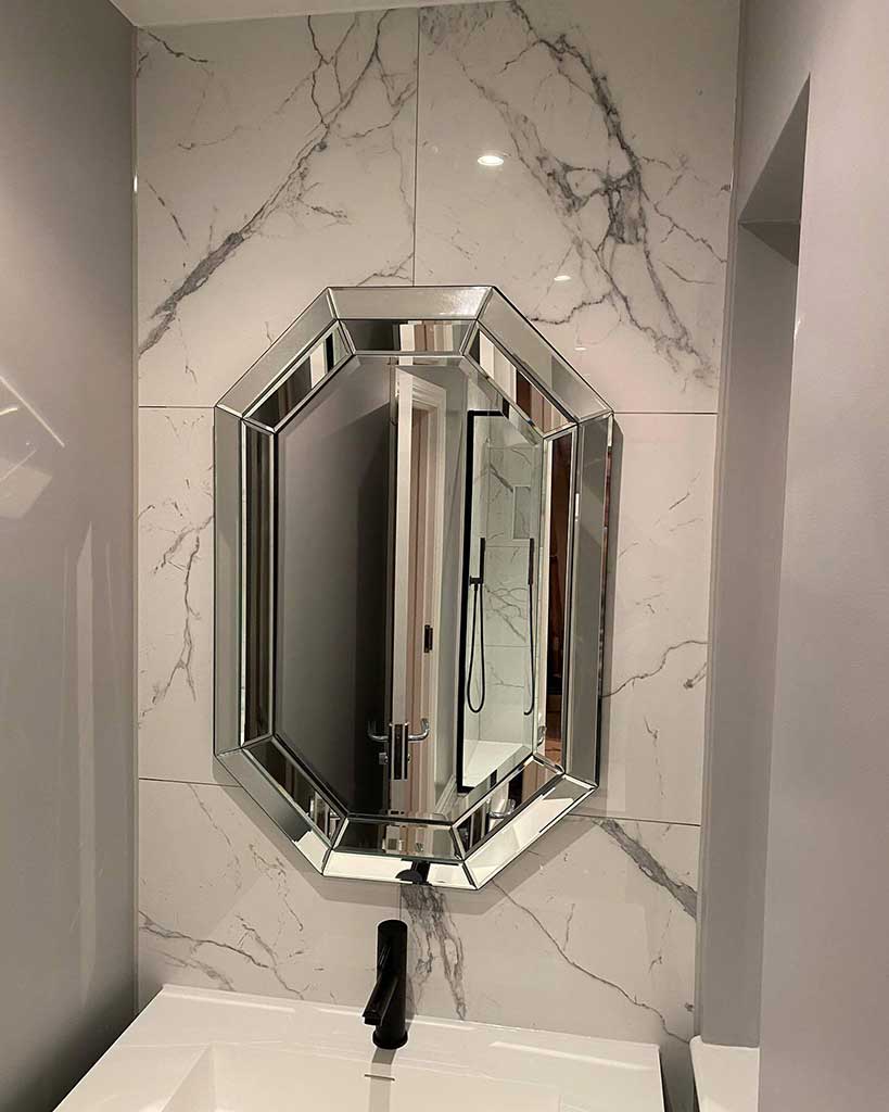 Basin and mirror on marble-effect tiles